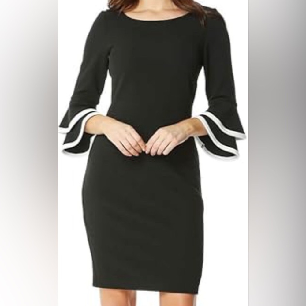 Long sleeve dark blue/black dress with ruffled sleeves.